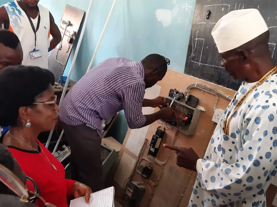 An instructor demonstrating an electrical board to trainees